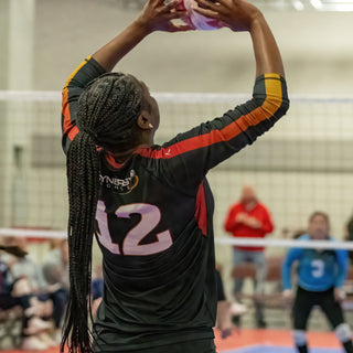 Volleyball player setting on the court